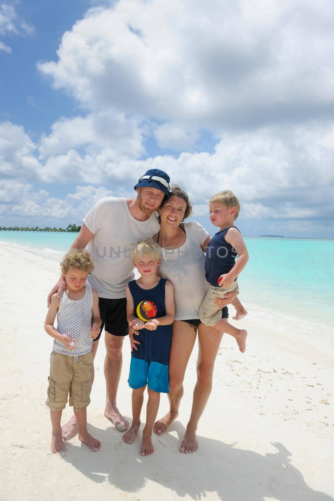 Portrait of a happy family on summer vacation  at beach