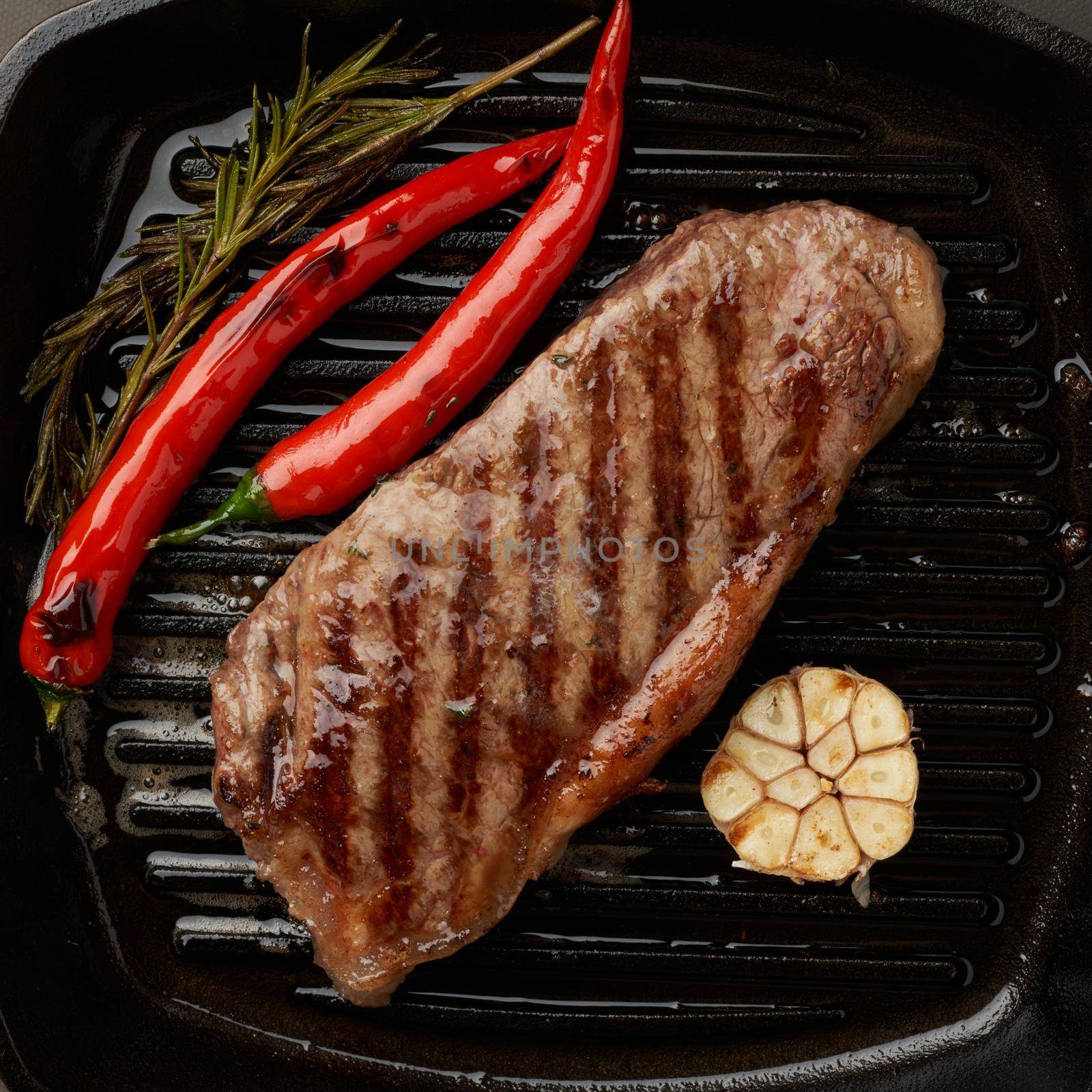 Keto ketogenic diet medium beef steak, fried striploin on grill pan. Paleo food by NataBene