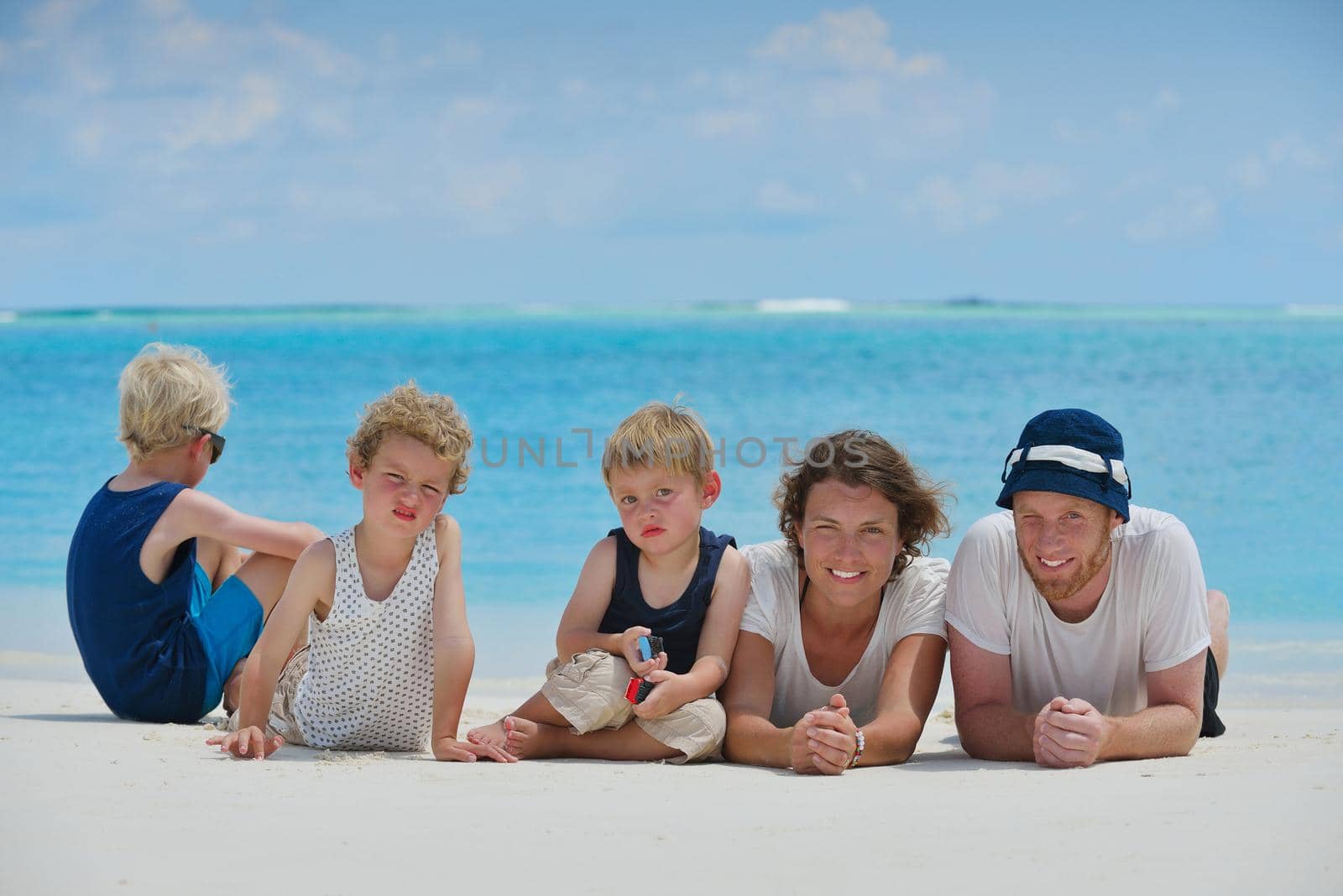 Portrait of a happy family on summer vacation  at beach