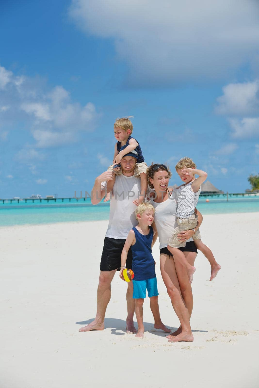 Portrait of a happy family on summer vacation  at beach