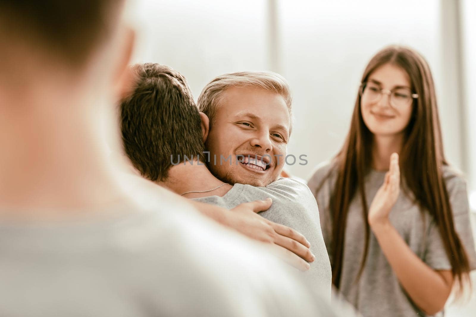 close up. happy contestants hugging each other. by SmartPhotoLab