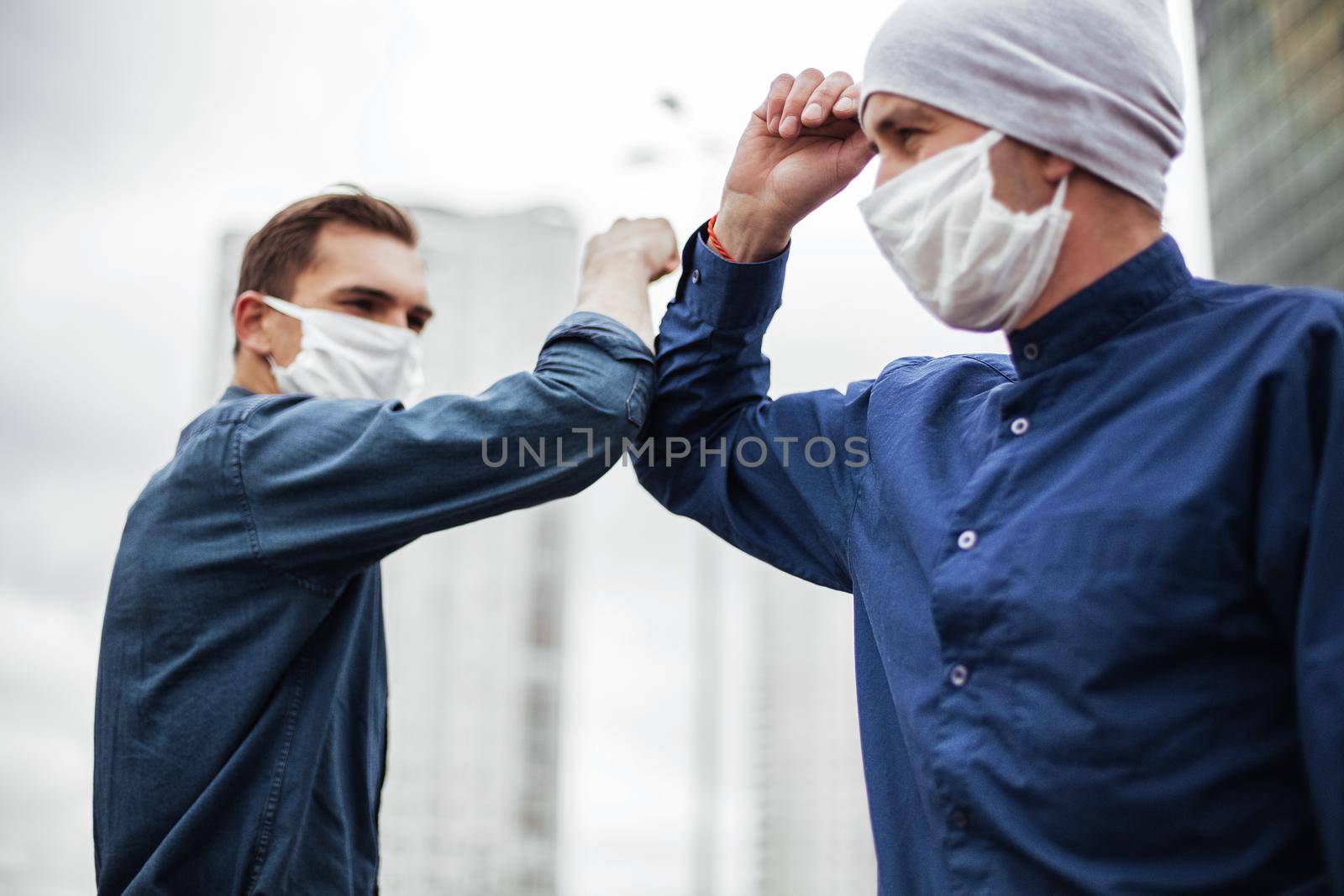 close up. two young men greeting each other with their elbows. concept of health protection