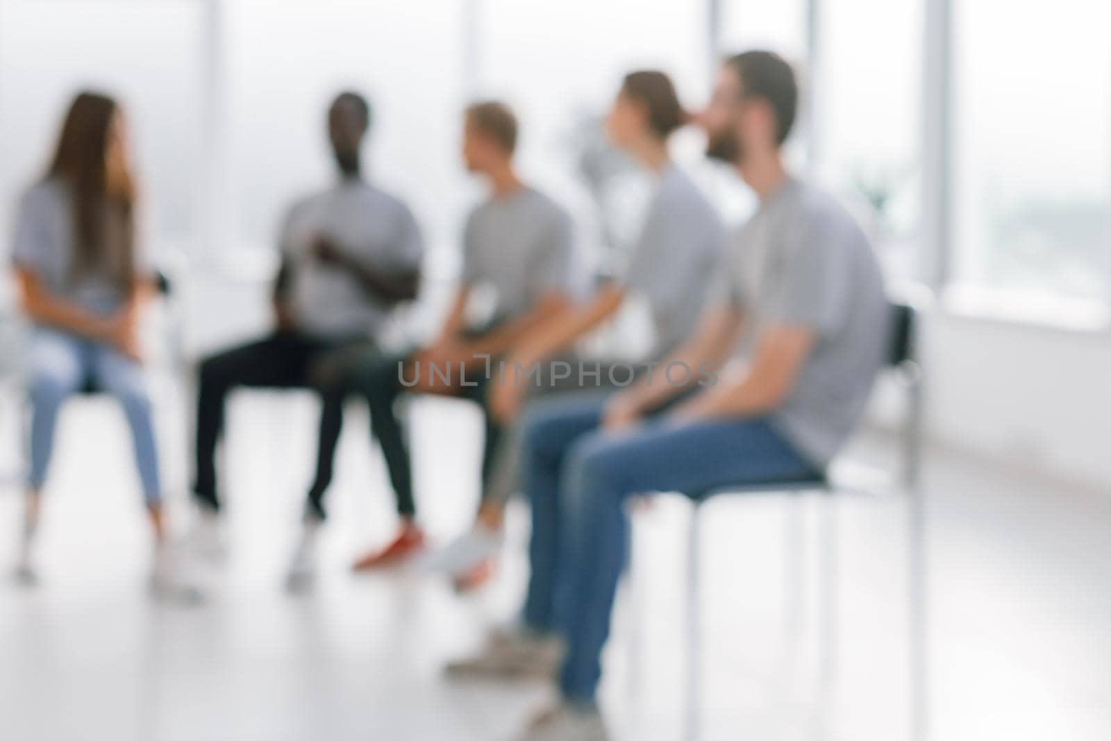 background image of a group of young people sitting in a circle. photo with copy space