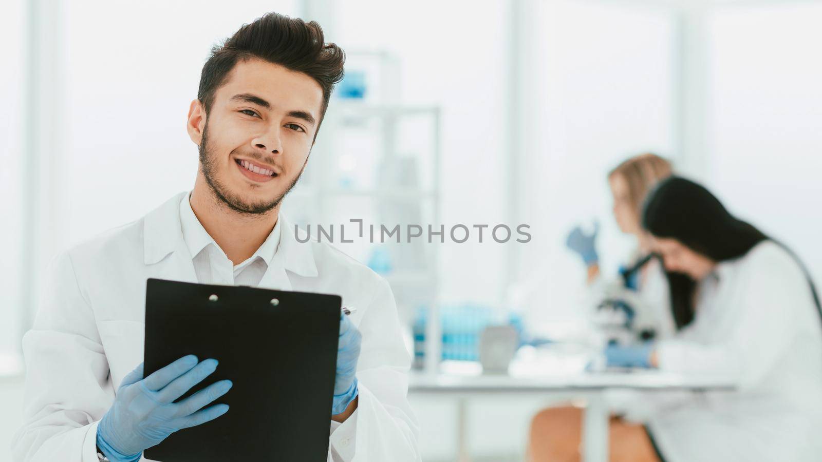 close up. a scientist doing writes the results of an experiment to a laboratory journal . photo with copy space