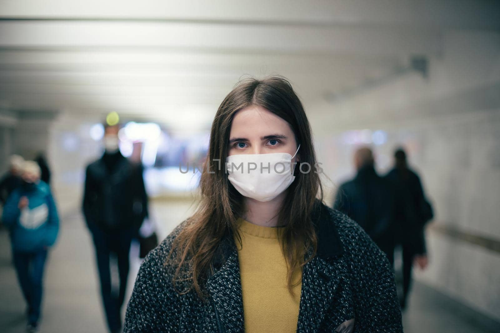 group of residents in protective masks walking in the underpass by SmartPhotoLab