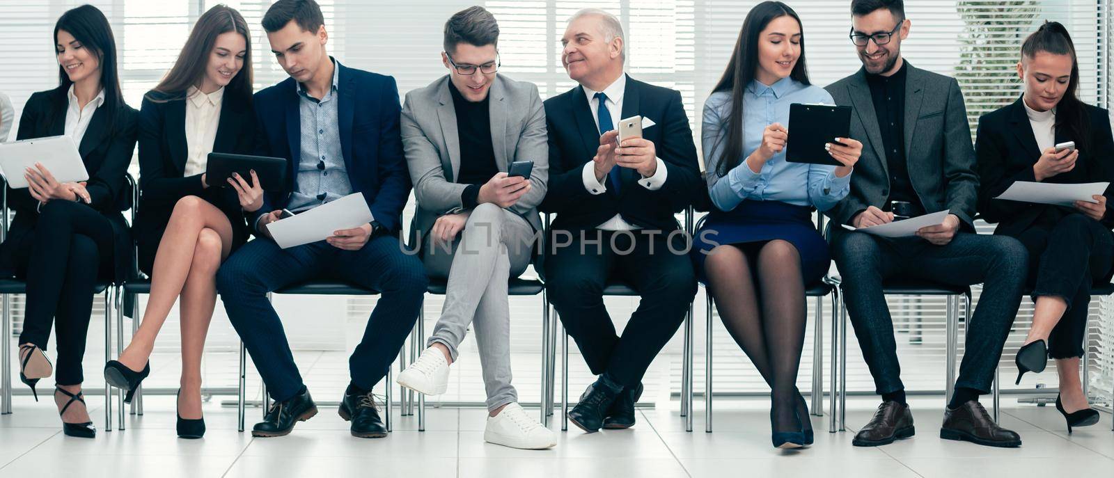 group of business people use their gadgets before starting a business meeting. photo with a copy of the space