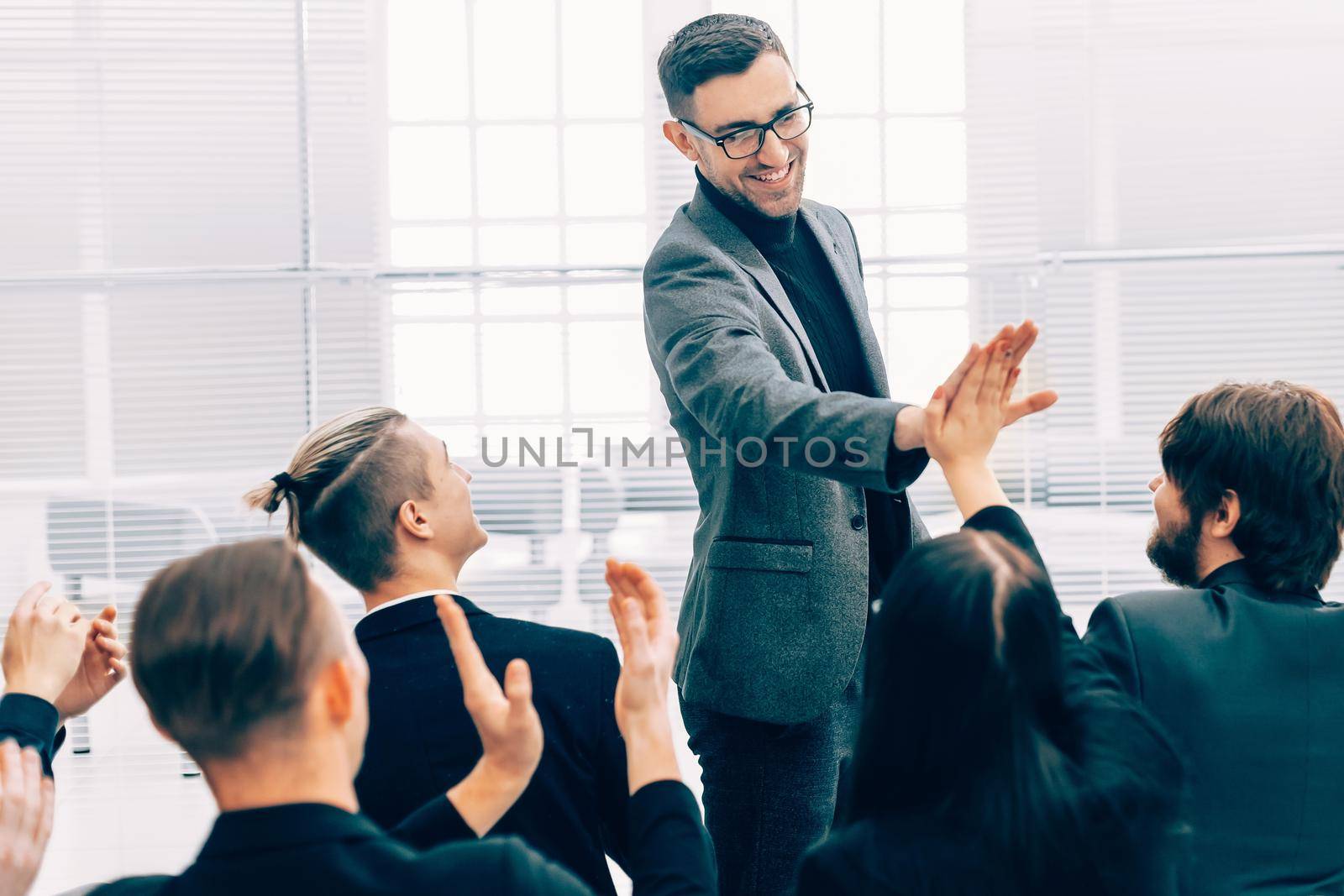 business colleagues giving each other a high five . the concept of success