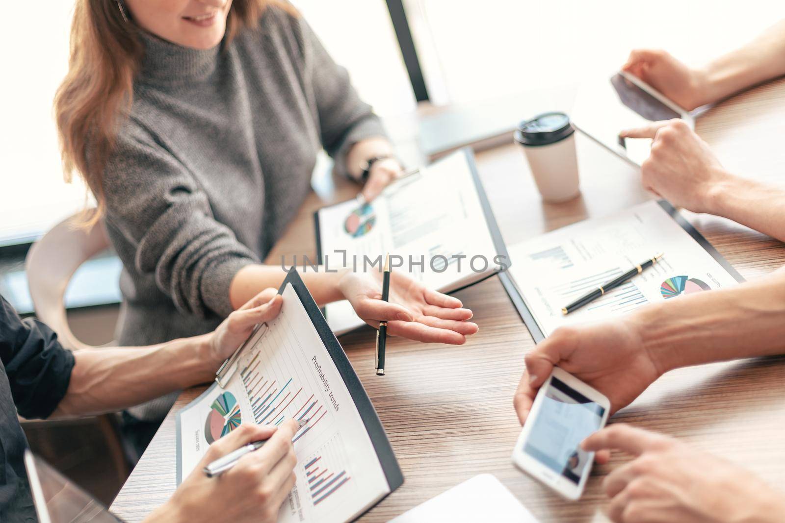 close up. employee is using his smartphone to check the financial data. business concept.