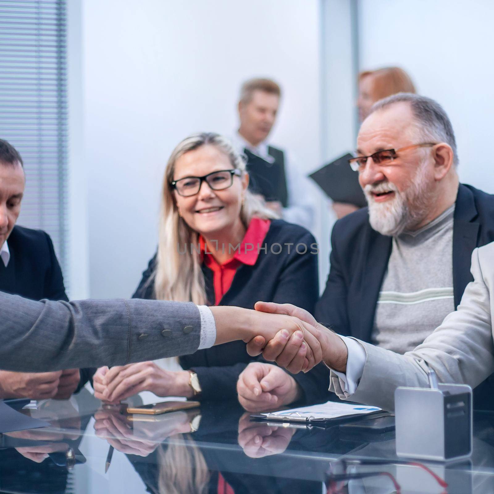 close up. business partners greet each other with a handshake. by SmartPhotoLab