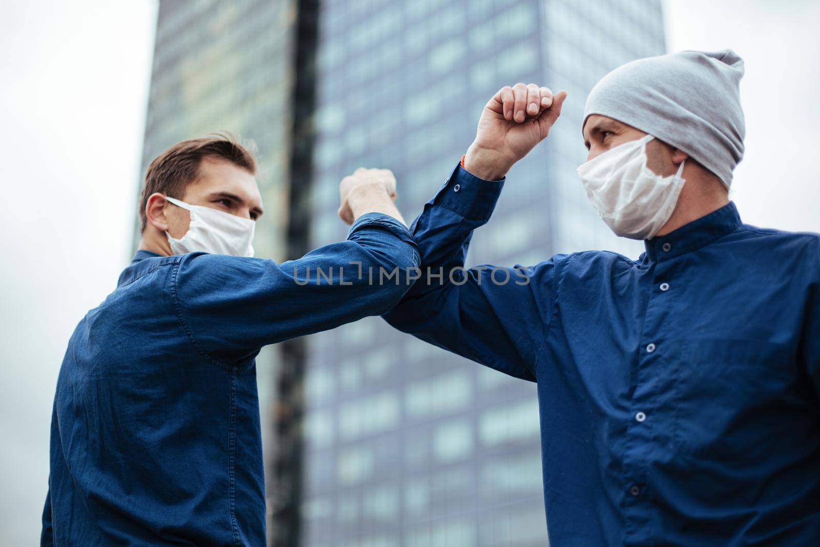 close up. two young men greeting each other with their elbows. concept of health protection