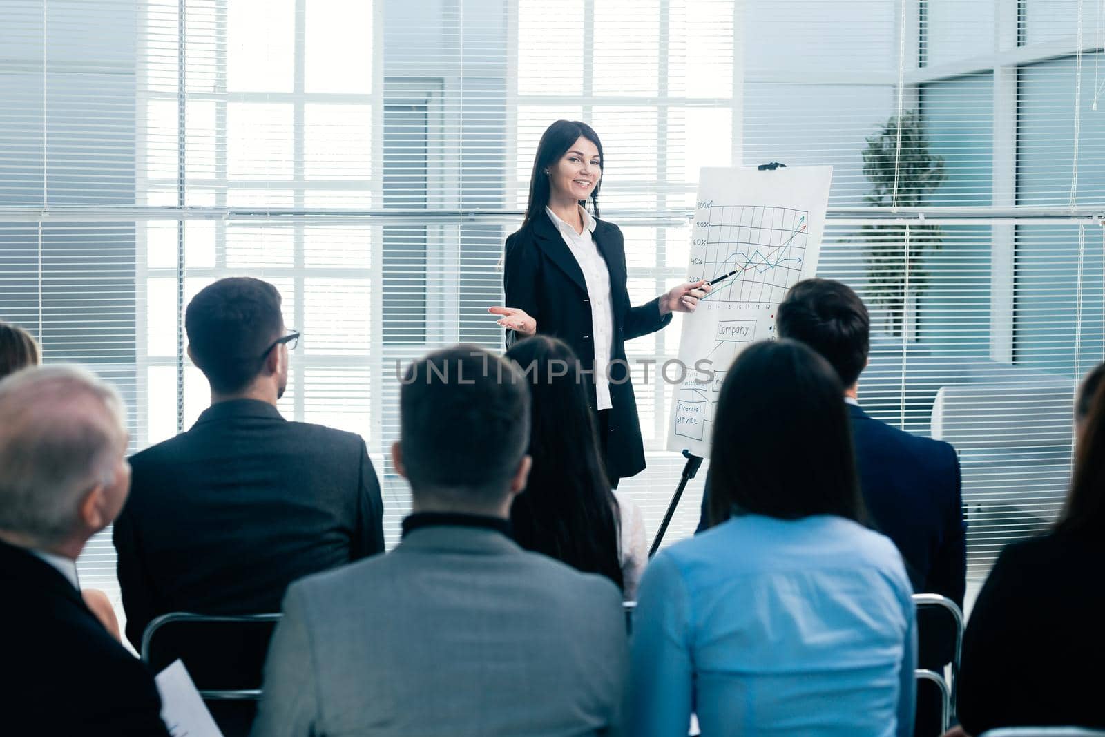 rear view. businesswoman making a presentation for the employees of the company