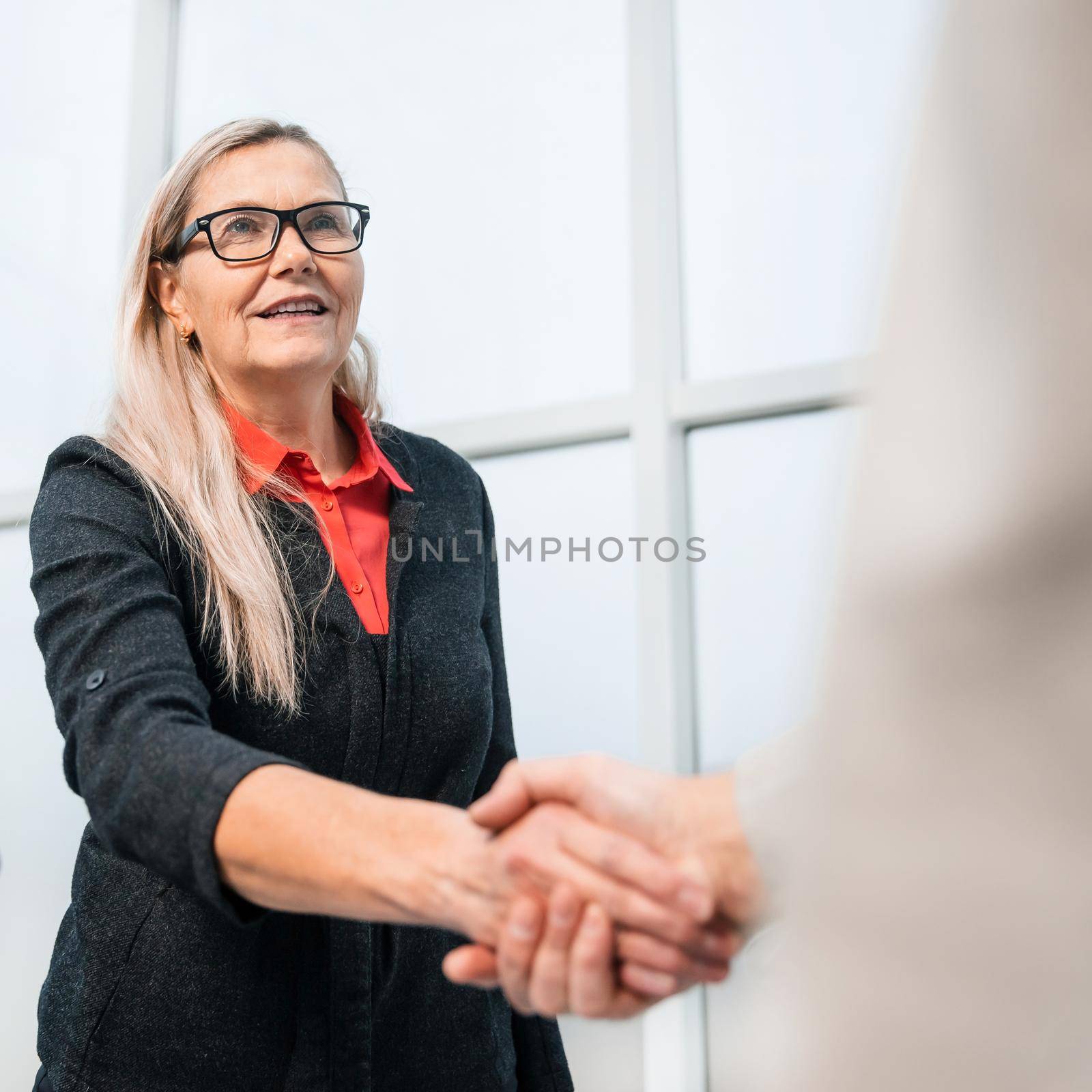 close up. confident business people shaking hands with each other by SmartPhotoLab