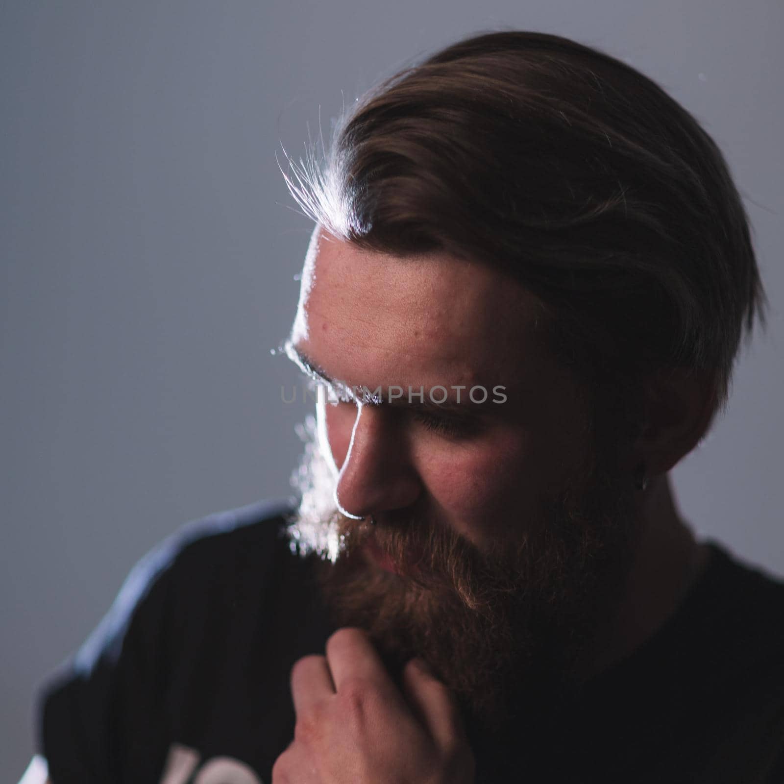 close up. portrait of a brooding bearded man . isolated on dark background