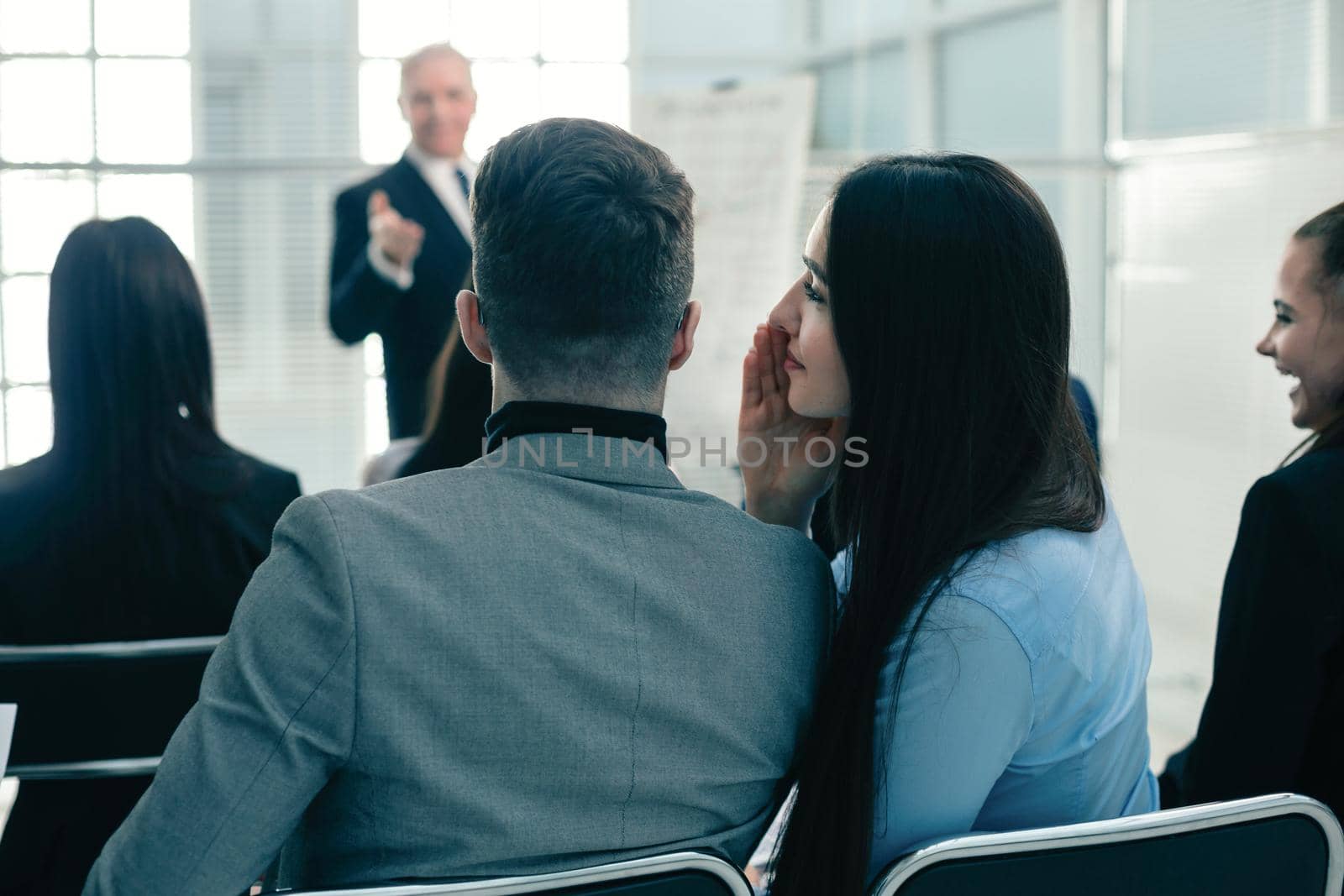rear view. colleagues discuss something during a business presentation