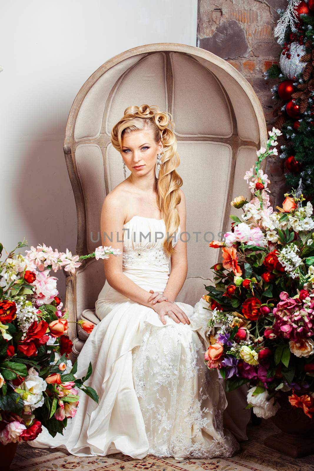 beauty young bride alone in luxury vintage interior with a lot of flowers, makeup and creative hairstyle close up