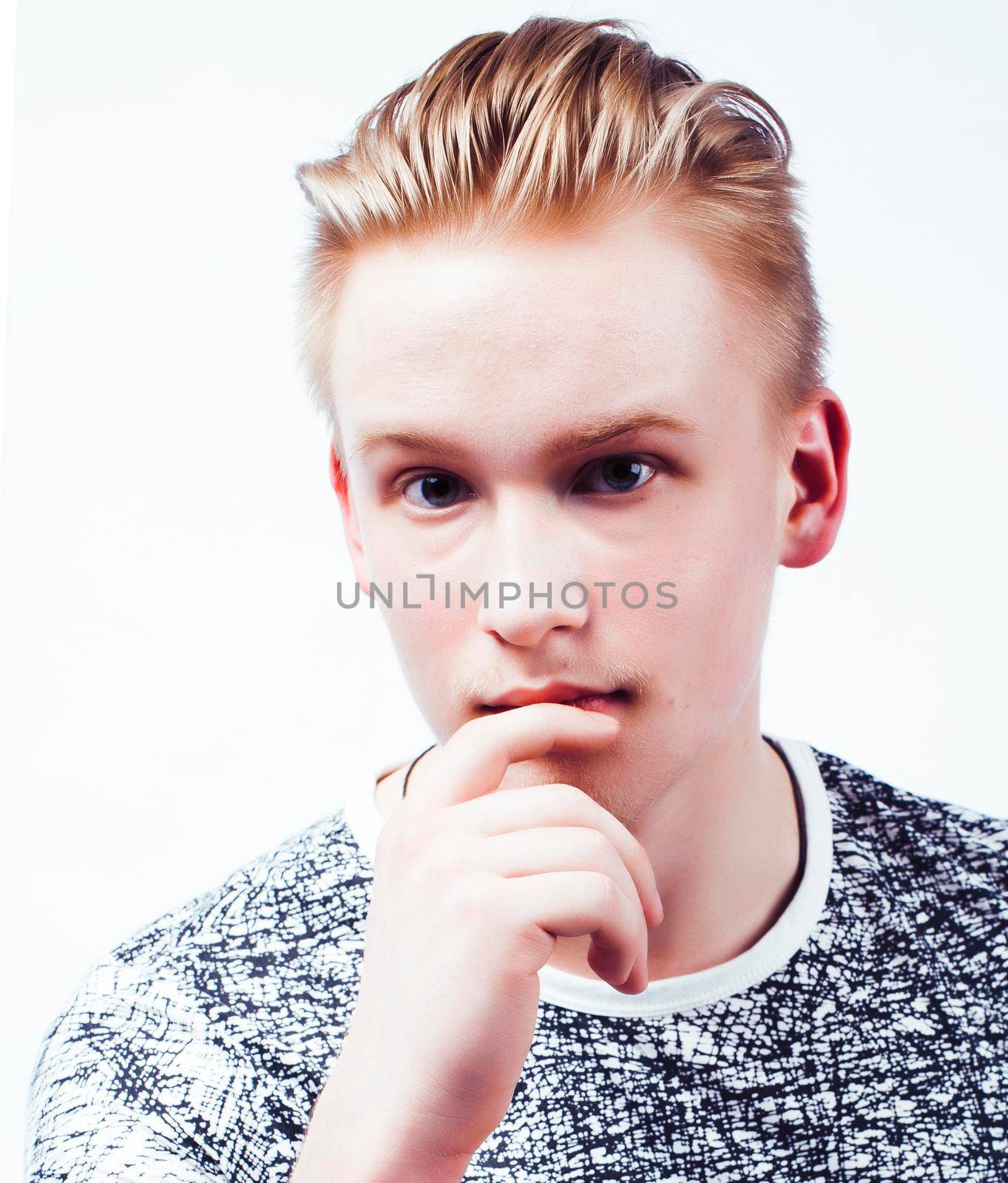 young handsome teenage hipster guy posing emotional, happy smiling against white background isolated, lifestyle people concept close up