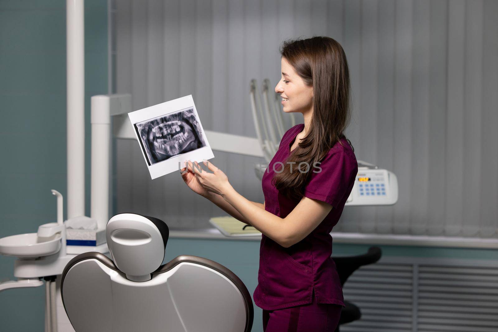 beautiful woman doctor with dental scans in hands in a dental clinic. High quality photo