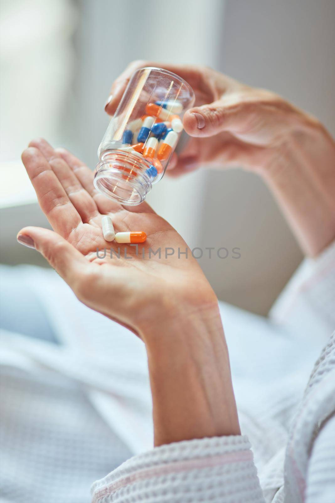 Woman pouring vitamin pills from transparent bottle on her palm, cropped. Beauty and cosmetology concept
