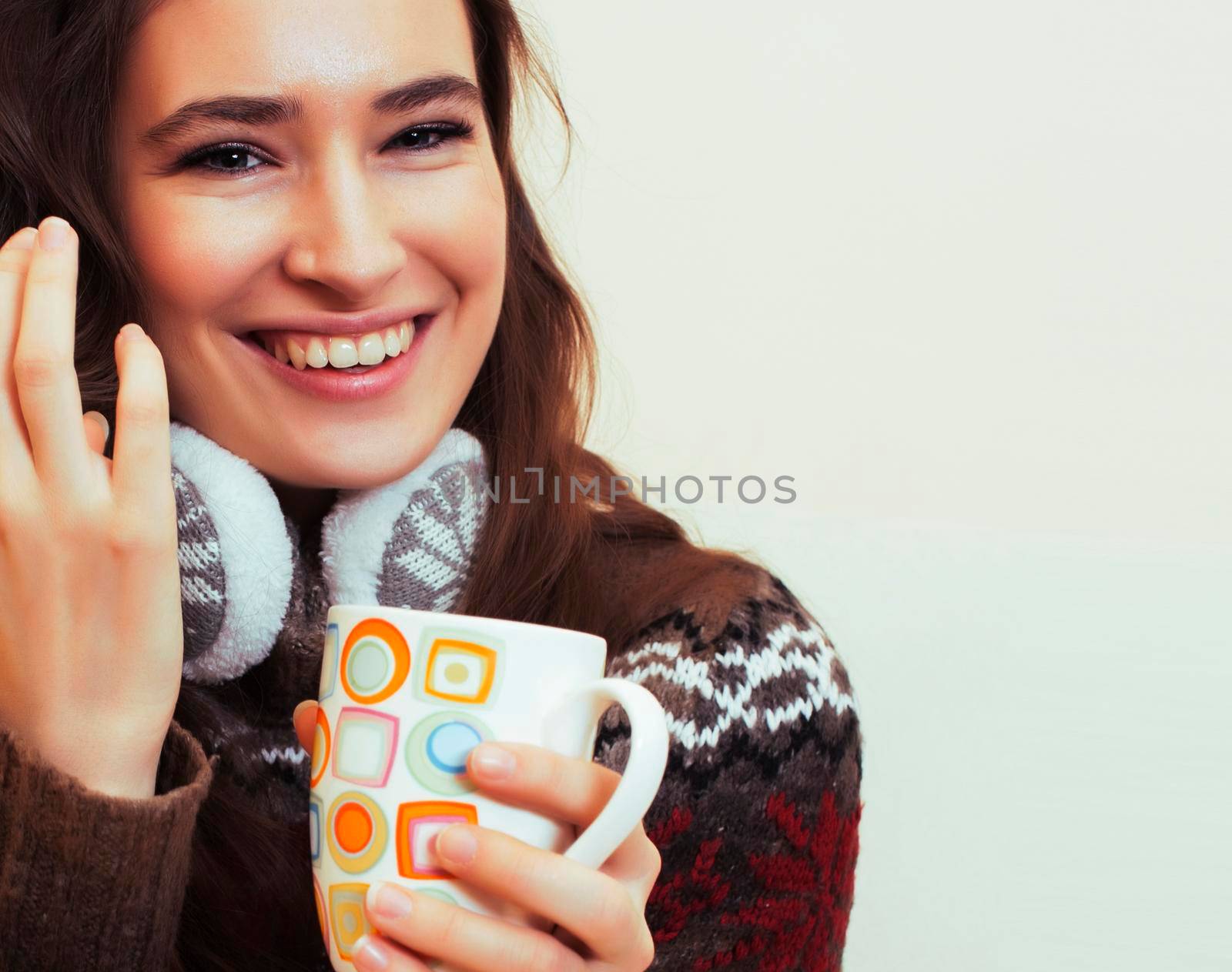 young pretty woman sitting in comfortable chair with coffee and blanket, winter season lifestyle people concept close up