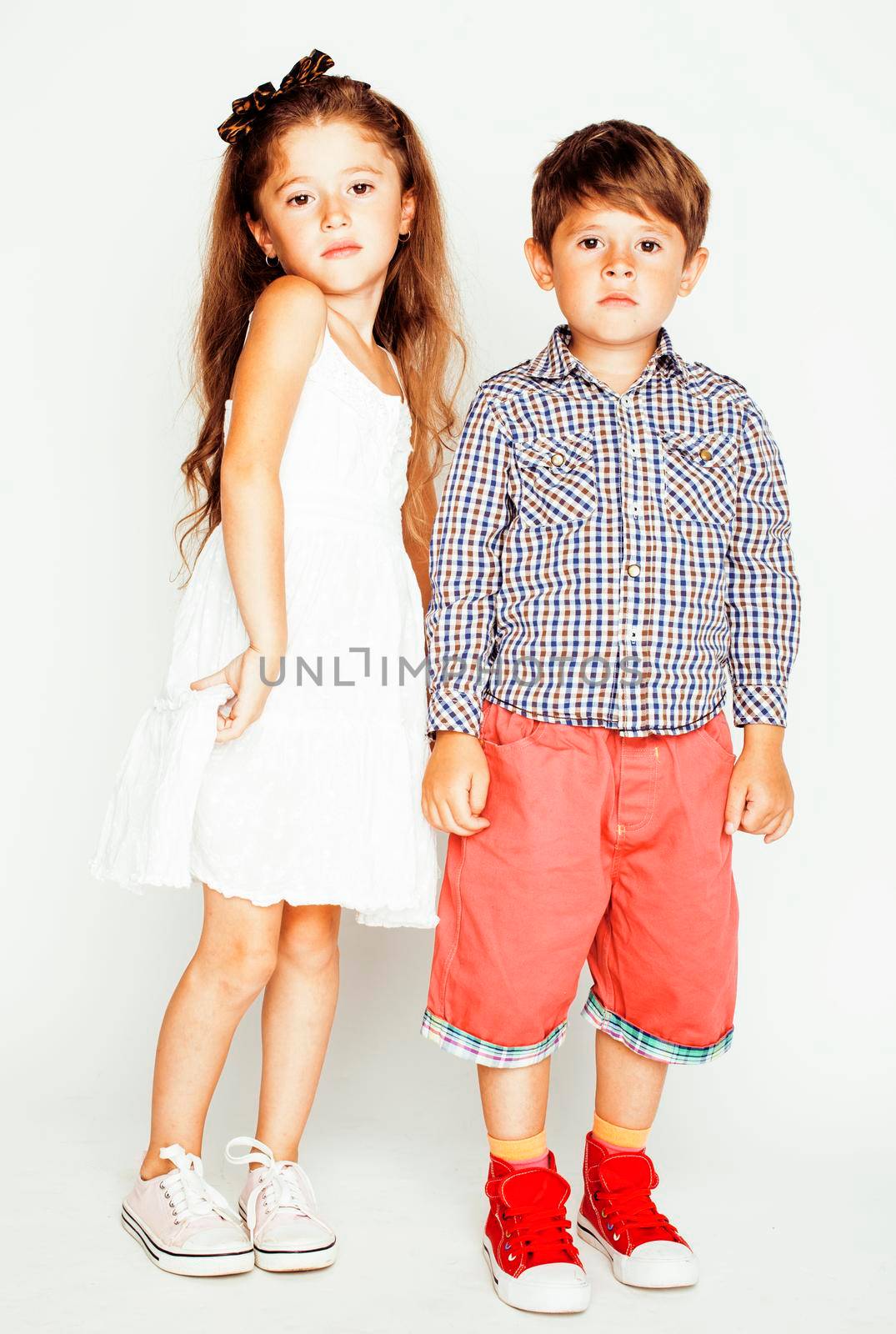 little cute boy and girl hugging playing on white background, happy family smiling close up