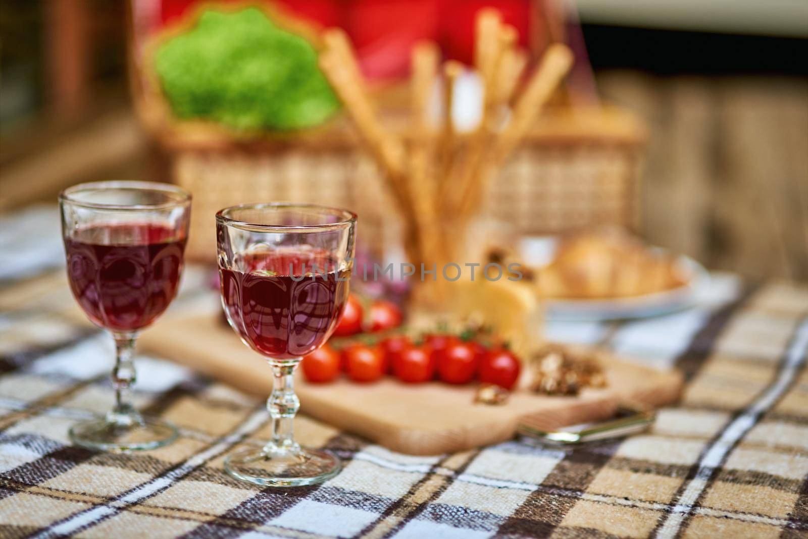 Cozy autumn picnic in the park with wine on warm plaid by friendsstock