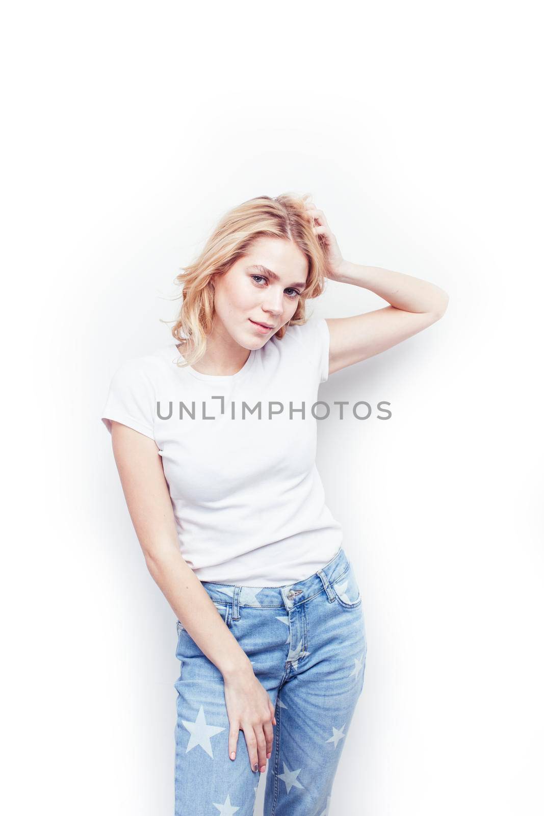 young pretty stylish blond hipster girl posing emotional isolated on white background happy smiling cool smile, lifestyle people concept close up