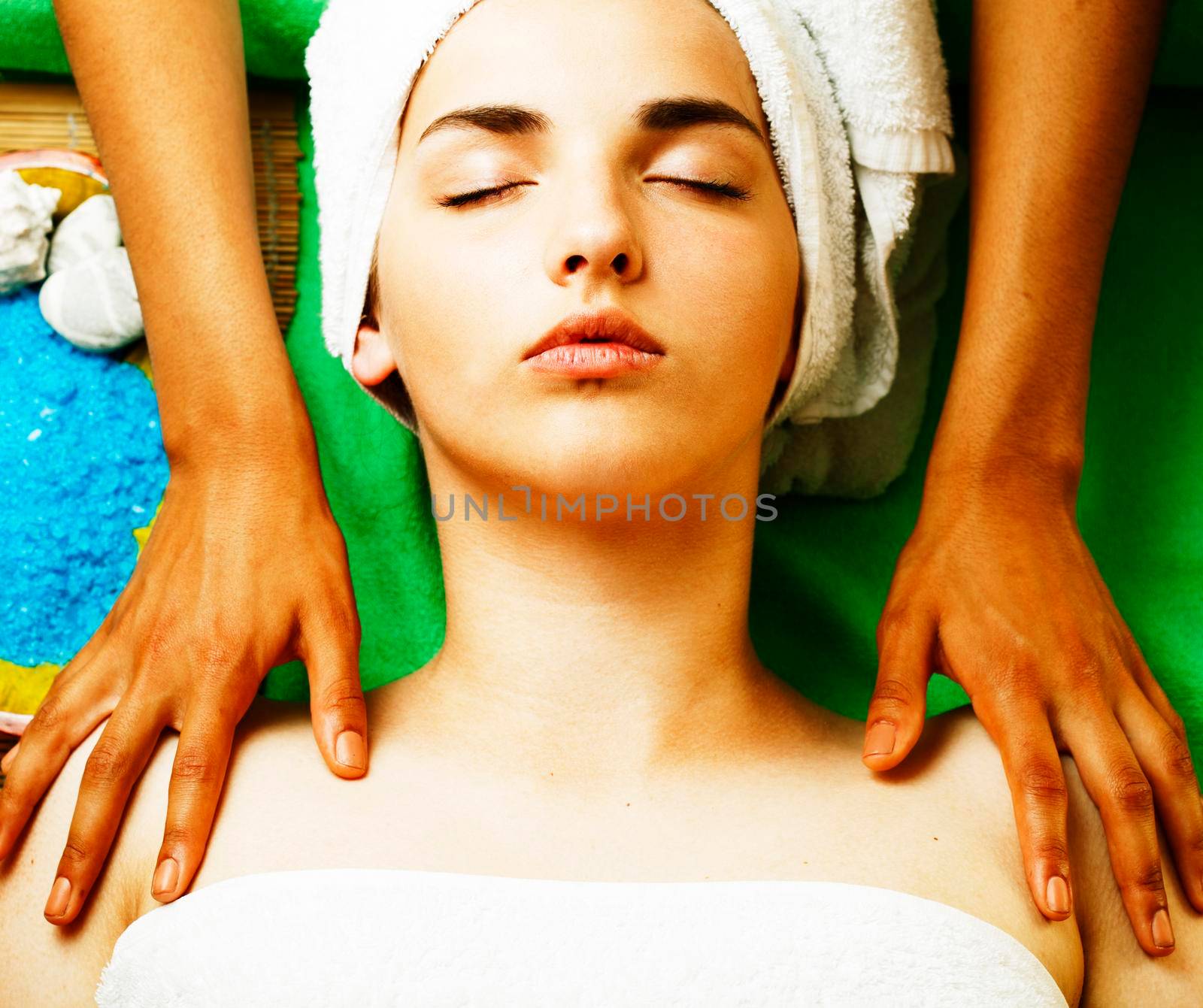 Attractive lady getting spa treatment in salon, closeup asian tan hands on face