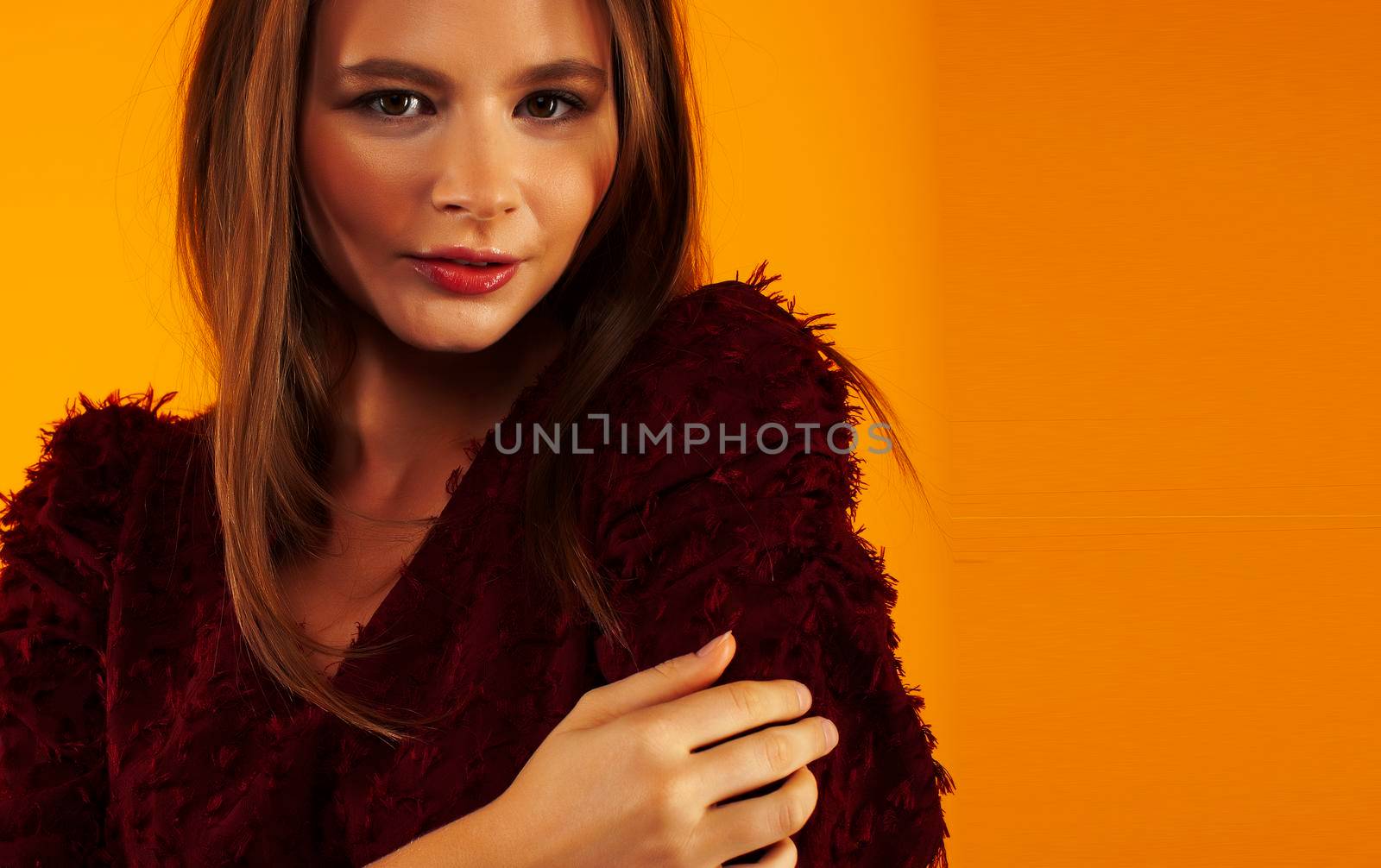 young pretty woman posing in fashion style on yellow background, lifestyle people concept close up
