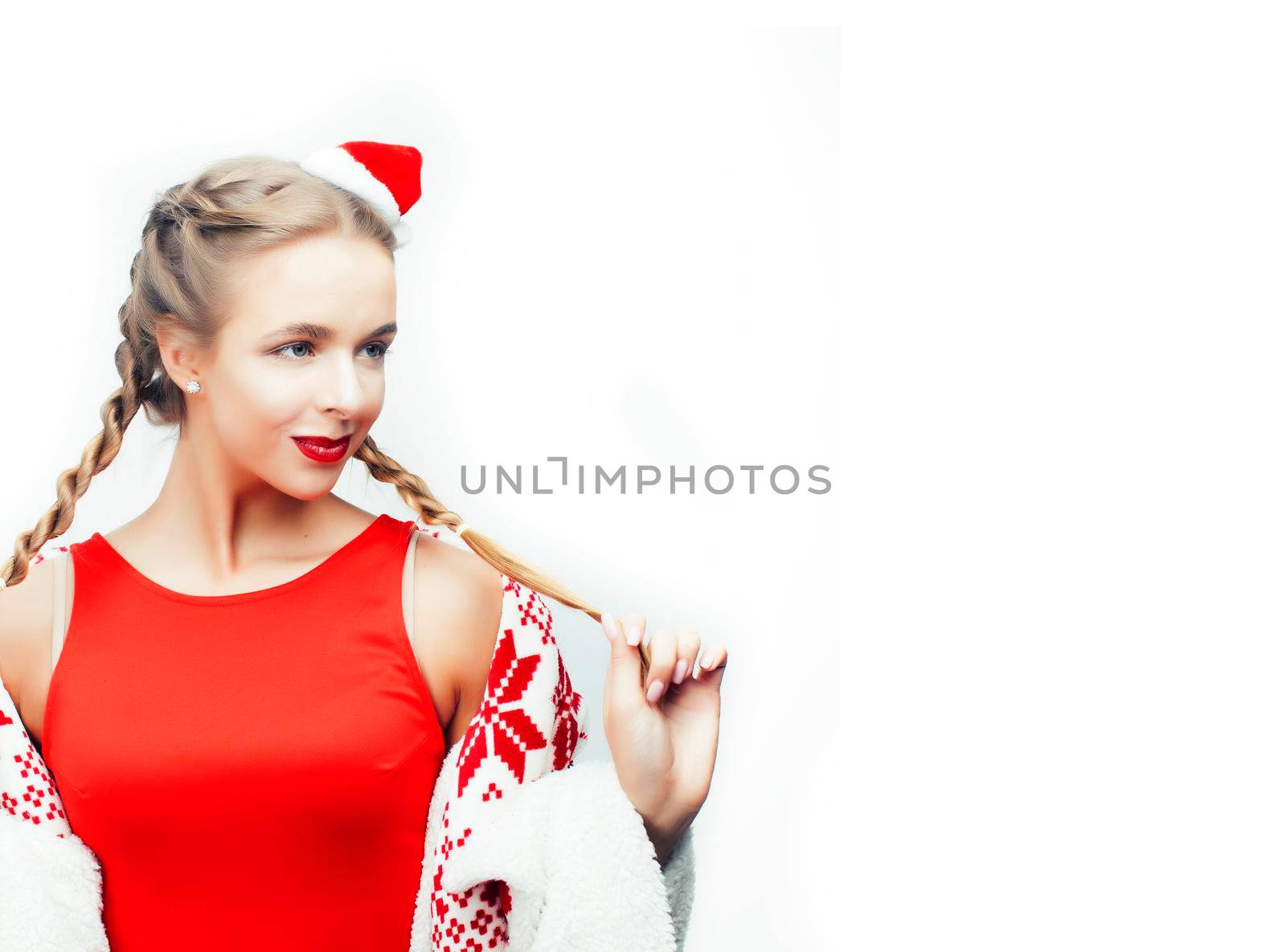 young pretty happy smiling woman on christmas in santas red hat posing isolated on white background, lifestyle people concept closeup