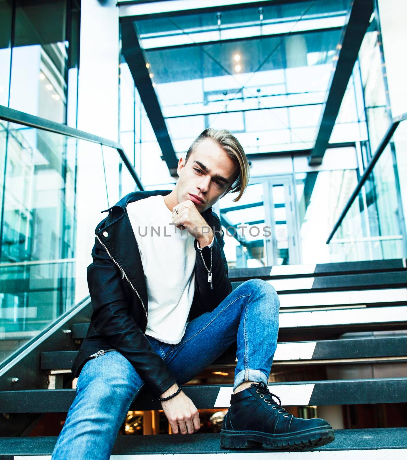 young modern hipster guy at new building university blond fashion handsome boy, lifestyle people concept by JordanJ