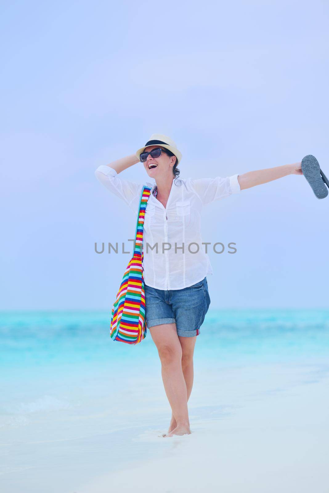 beautifel and happy woman girl on beach have fun and relax on summer vacation  over the beautiful tropical sea