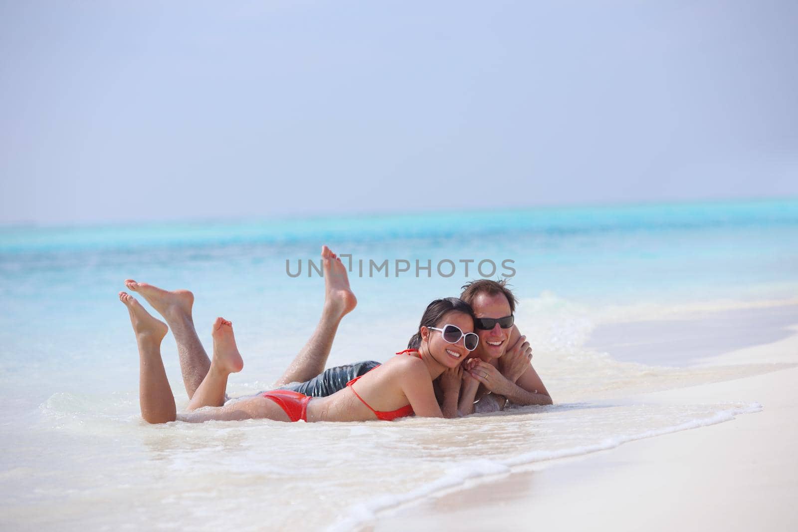 happy young romantic couple in love have fun running and relaxing on beautiful beach