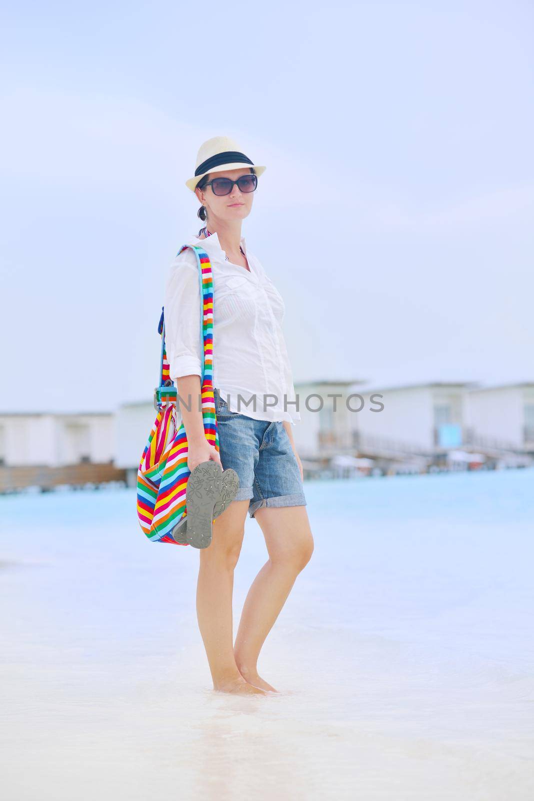 beautiful woman on beach have fun and relax by dotshock