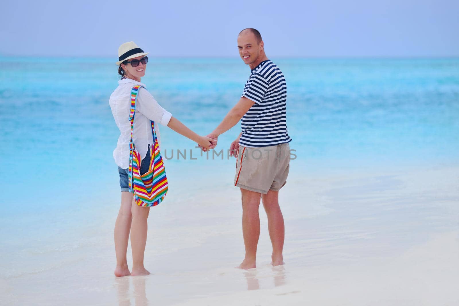 happy young romantic couple in love have fun running and relaxing on beautiful beach