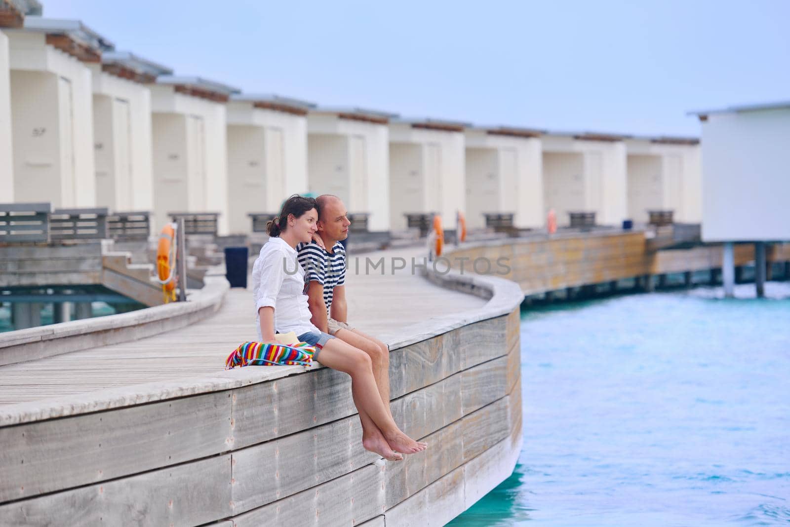 happy young couple have fun on beach by dotshock