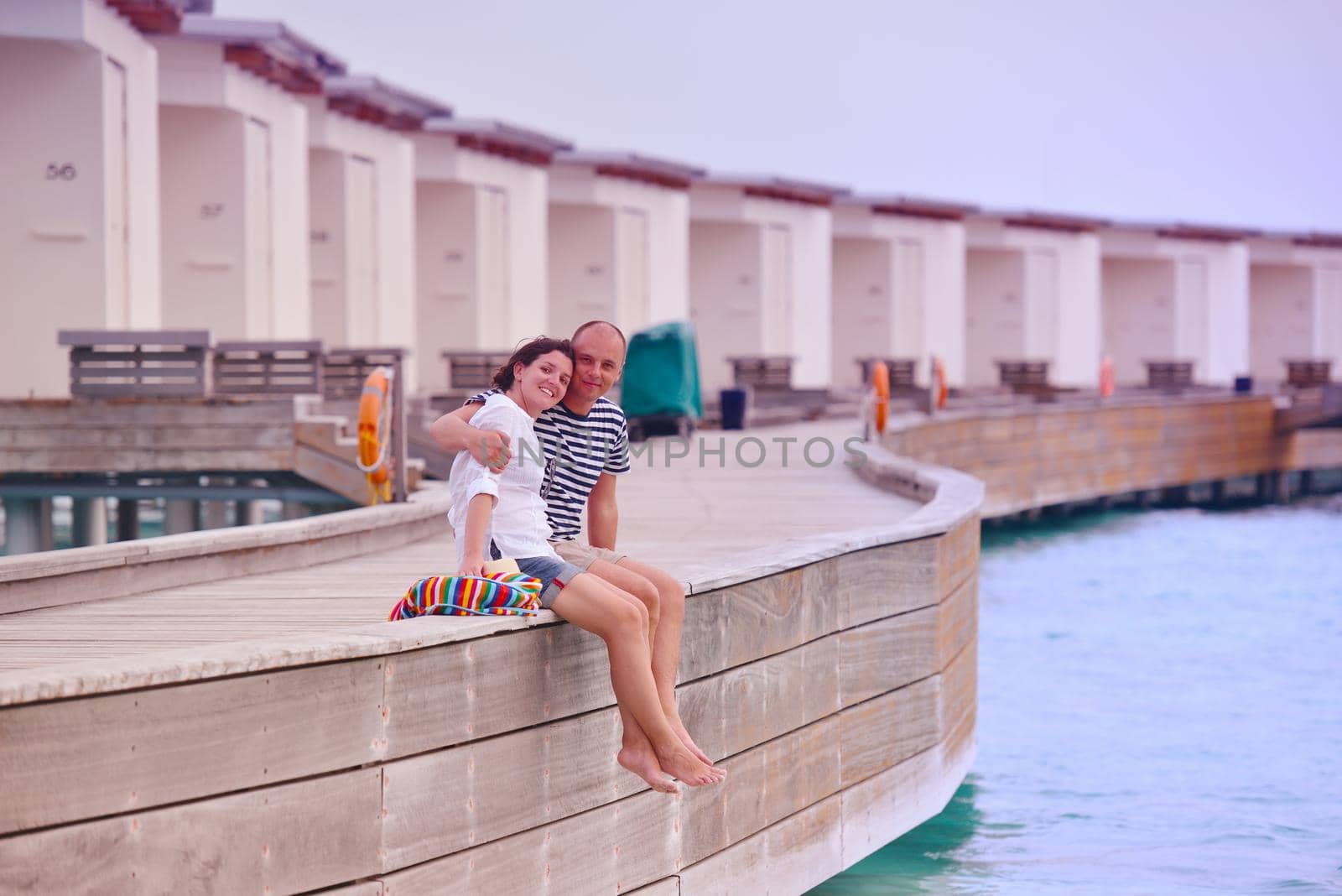 happy young couple have fun on beach by dotshock