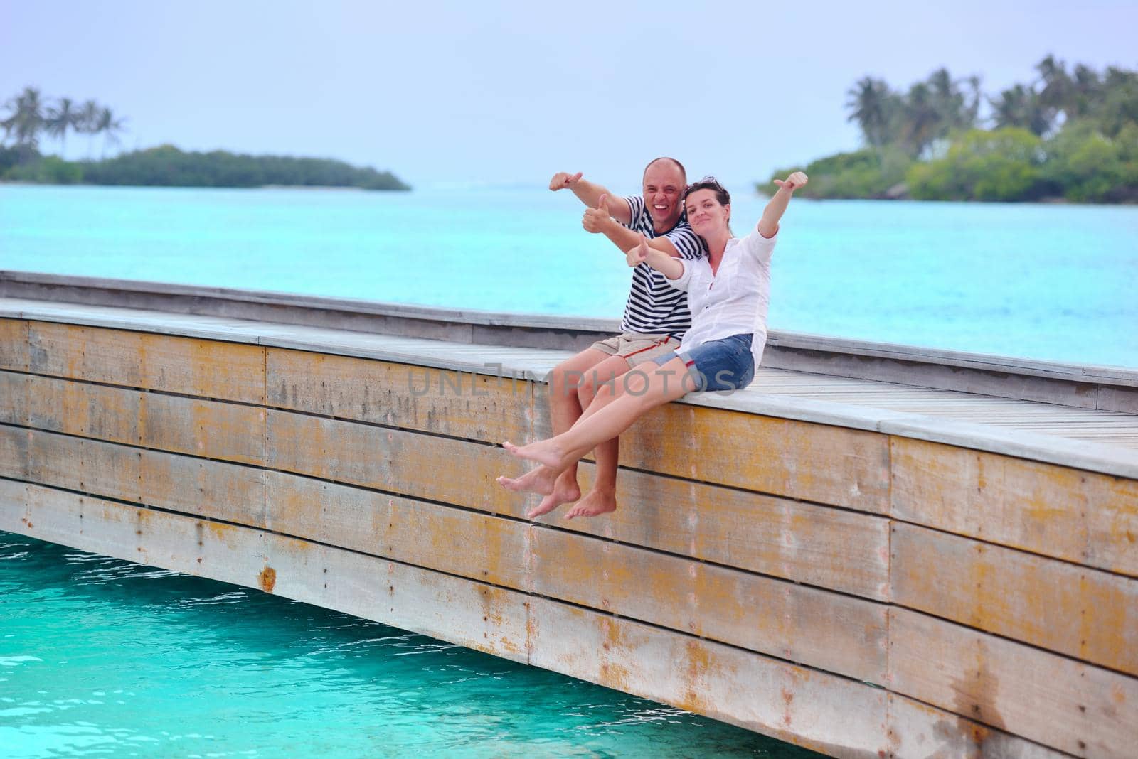 happy young couple have fun on beach by dotshock