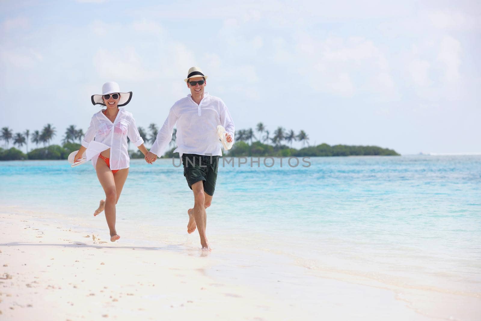 happy young romantic couple in love have fun running and relaxing on beautiful beach