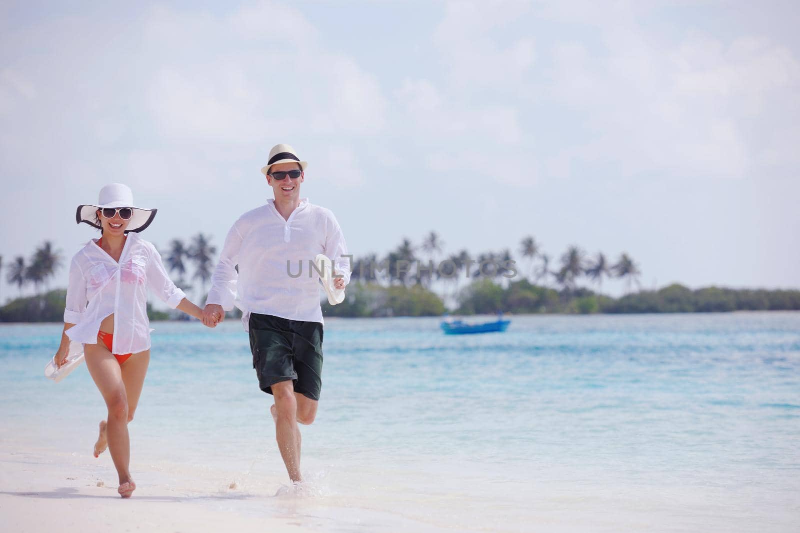 happy young romantic couple in love have fun running and relaxing on beautiful beach