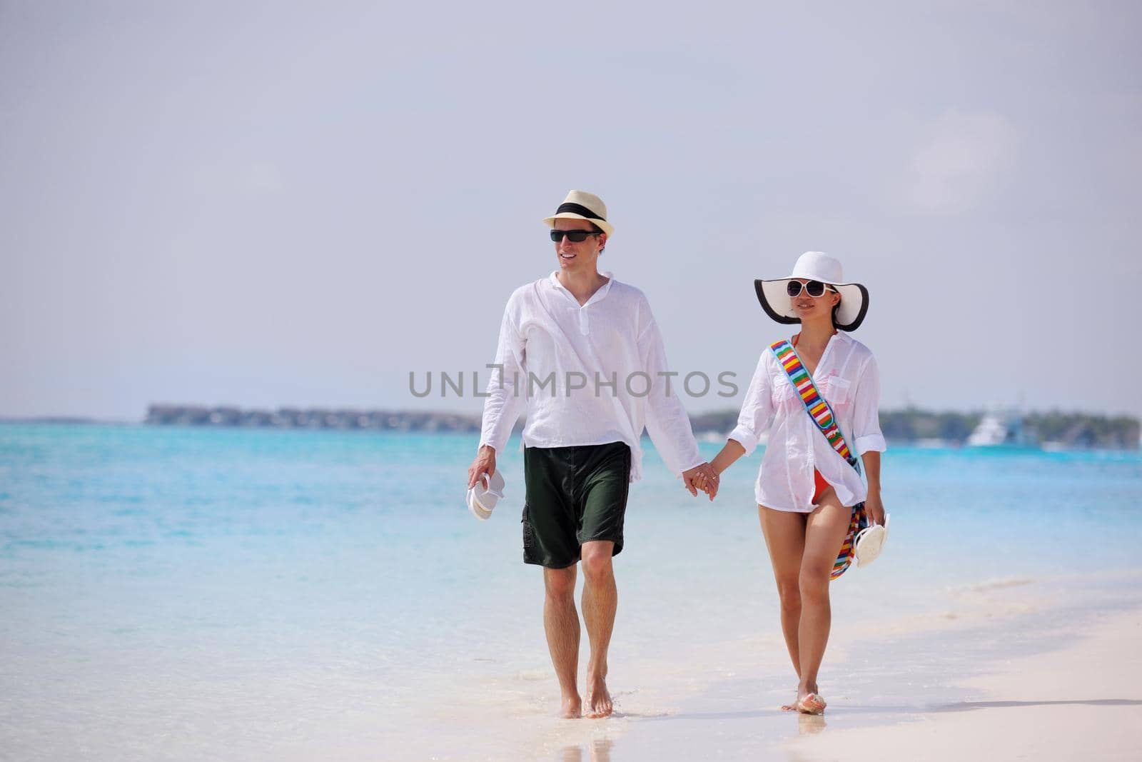 happy young romantic couple in love have fun running and relaxing on beautiful beach