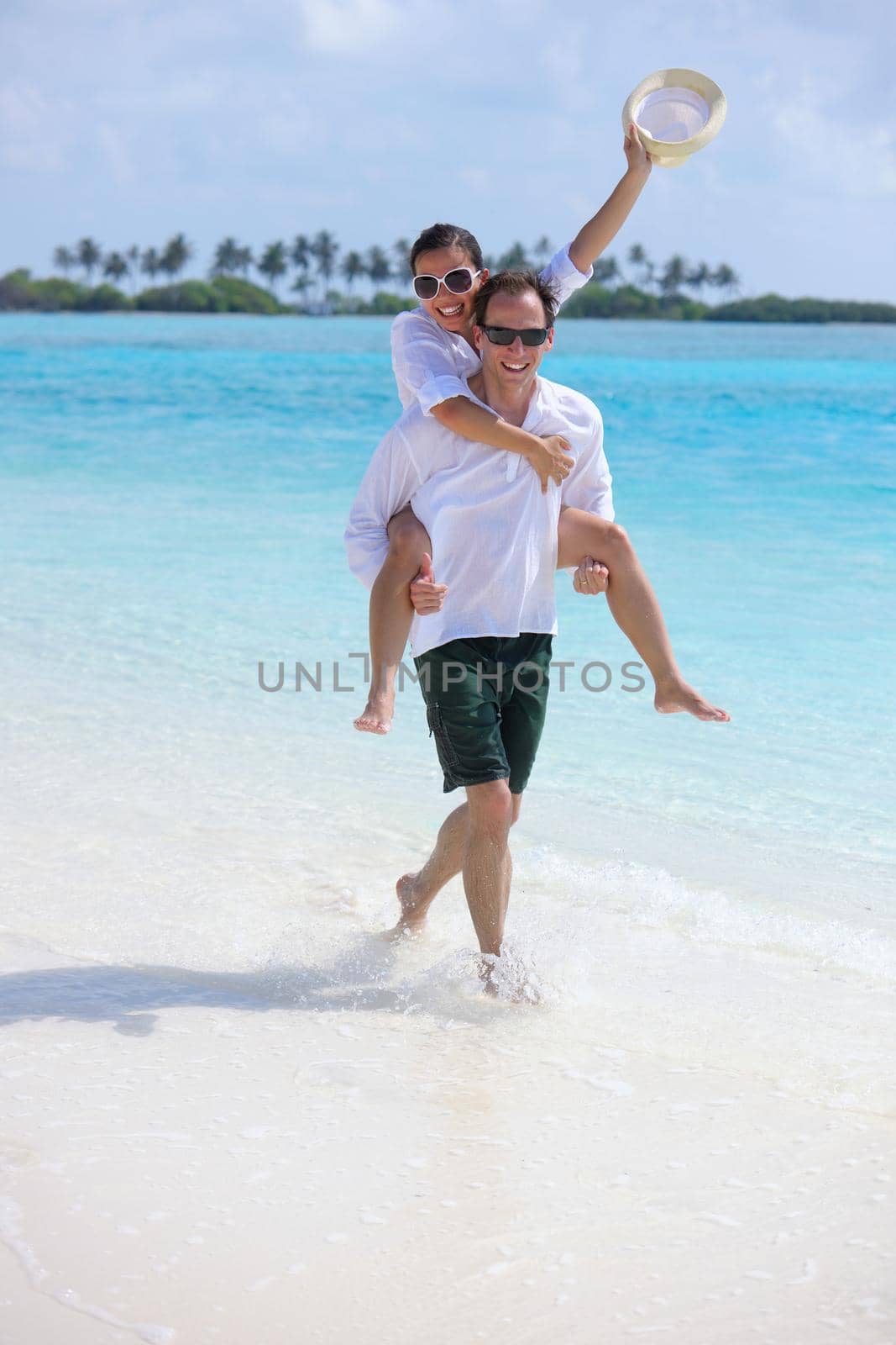 happy young romantic couple in love have fun running and relaxing on beautiful beach