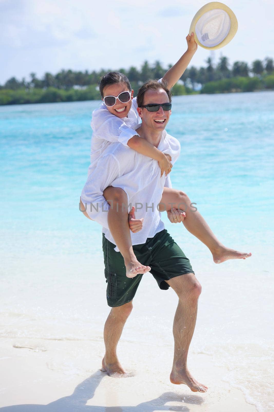 happy young romantic couple in love have fun running and relaxing on beautiful beach