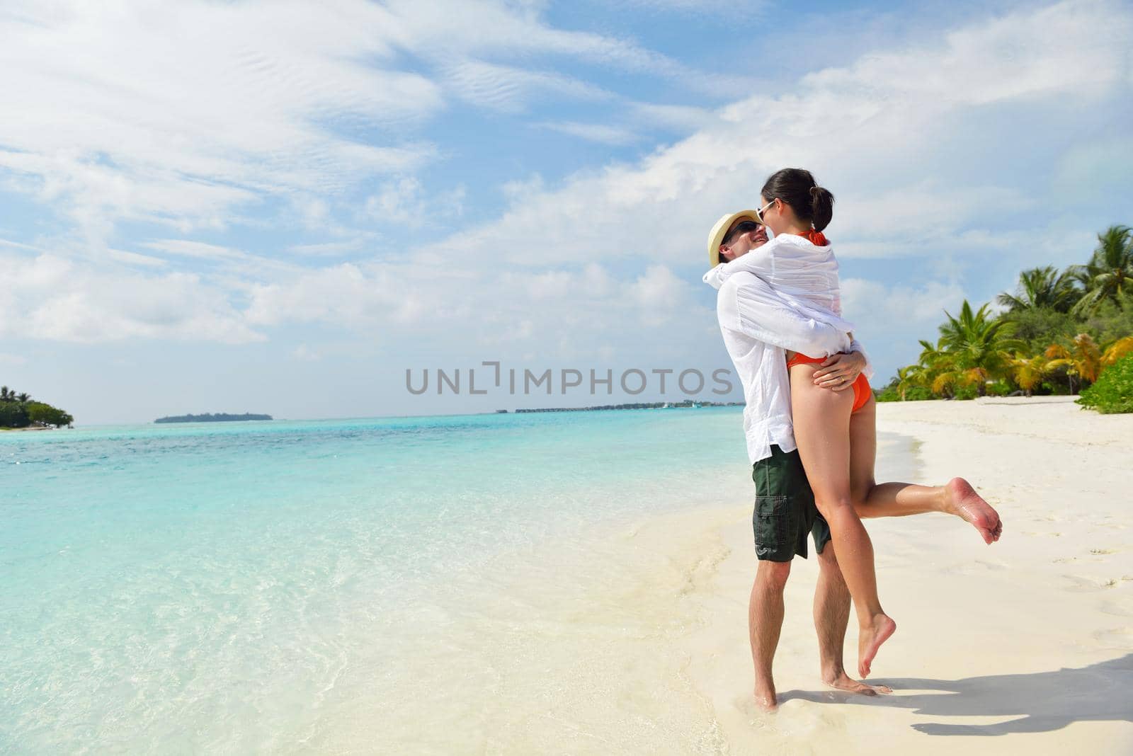 happy young romantic couple in love have fun running and relaxing on beautiful beach