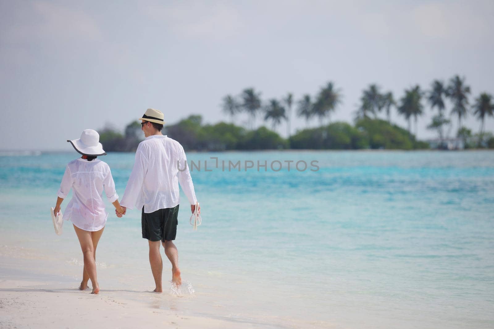 happy young romantic couple in love have fun running and relaxing on beautiful beach