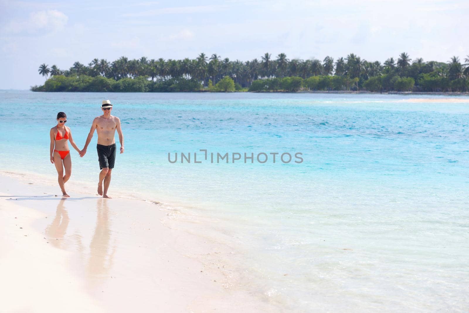 happy young romantic couple in love have fun running and relaxing on beautiful beach