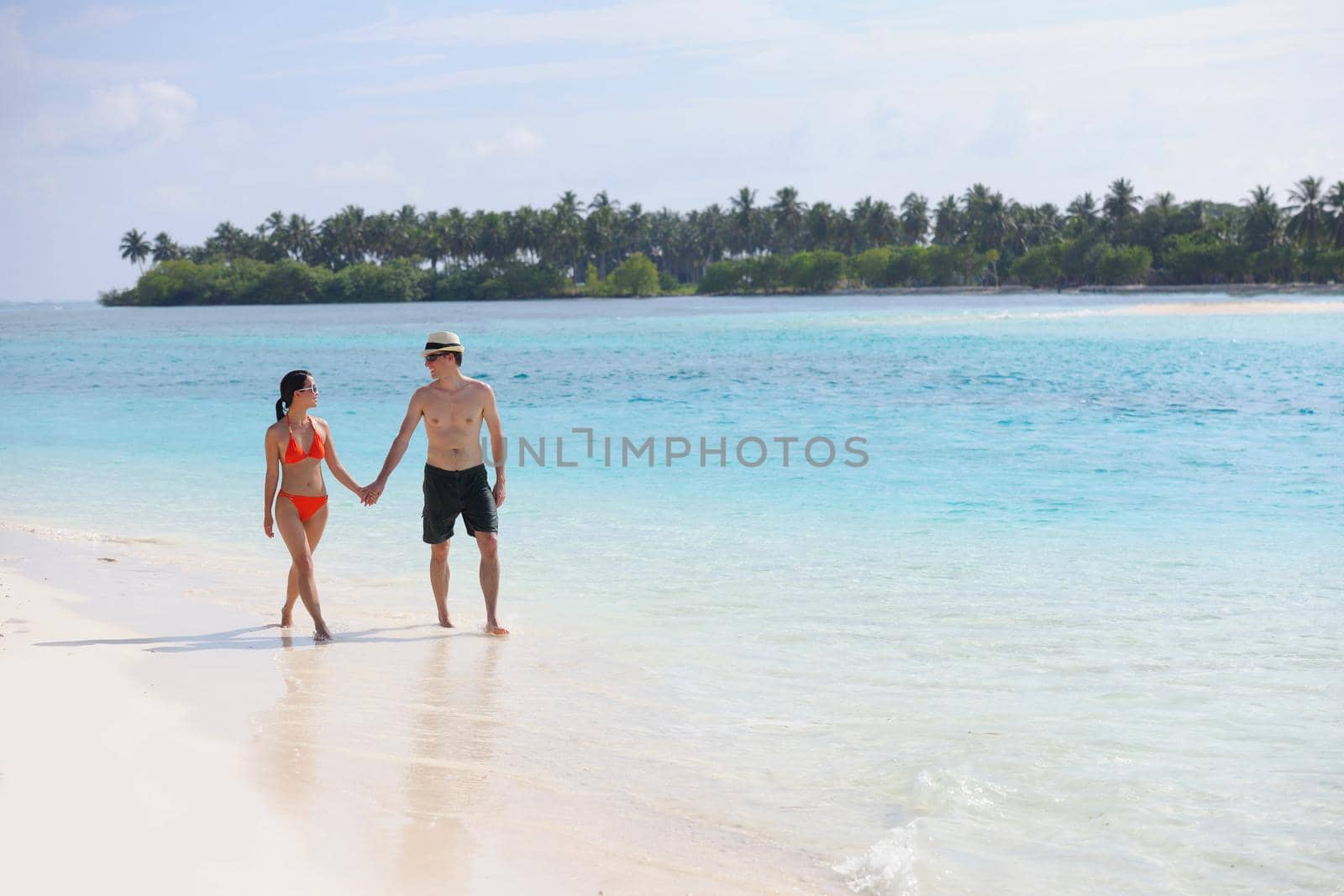 happy young romantic couple in love have fun running and relaxing on beautiful beach