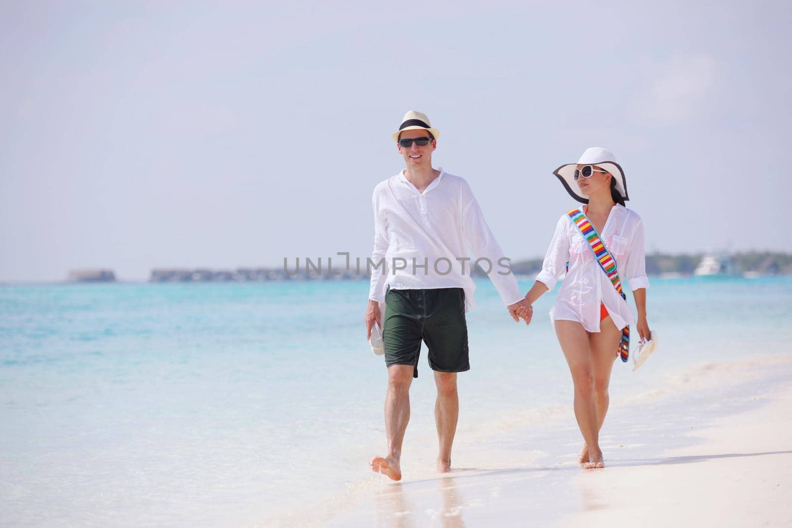 happy young romantic couple in love have fun running and relaxing on beautiful beach