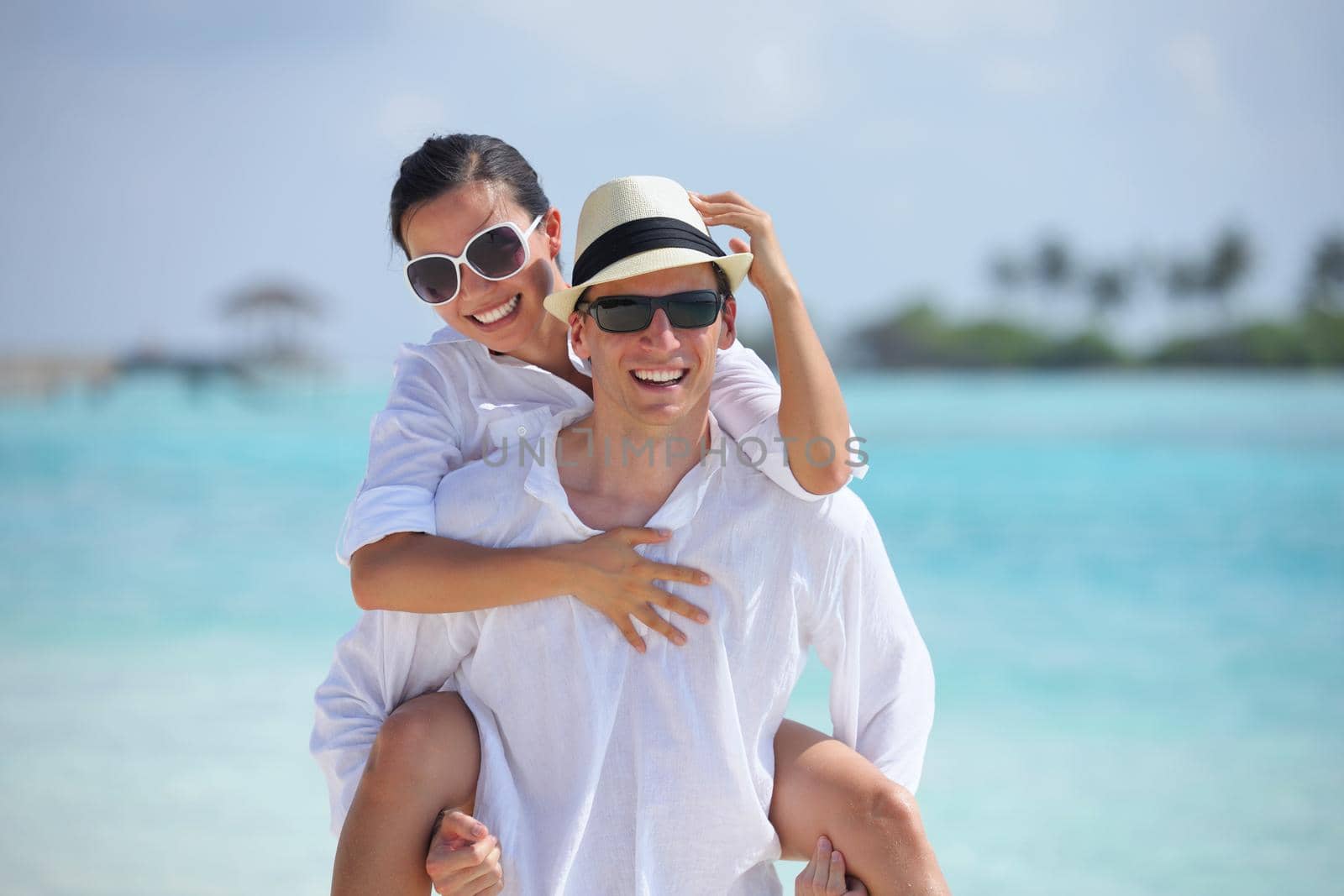 happy young romantic couple in love have fun running and relaxing on beautiful beach