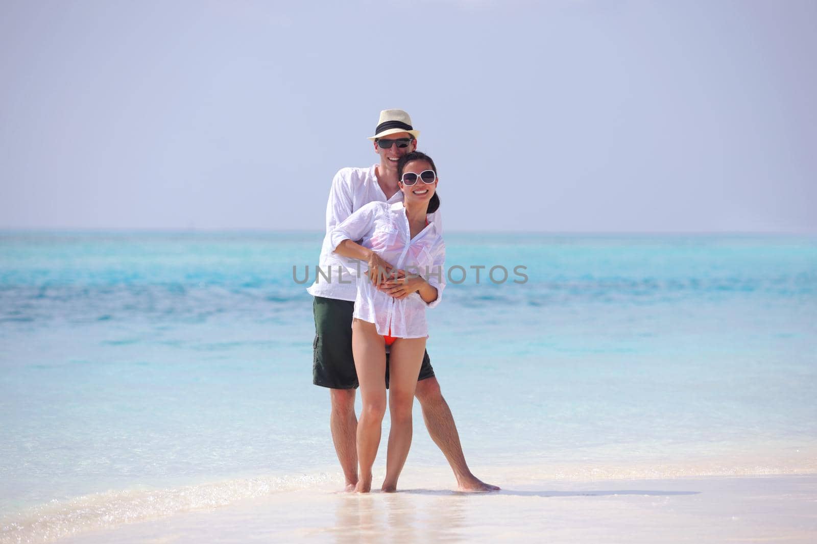 happy young romantic couple in love have fun running and relaxing on beautiful beach