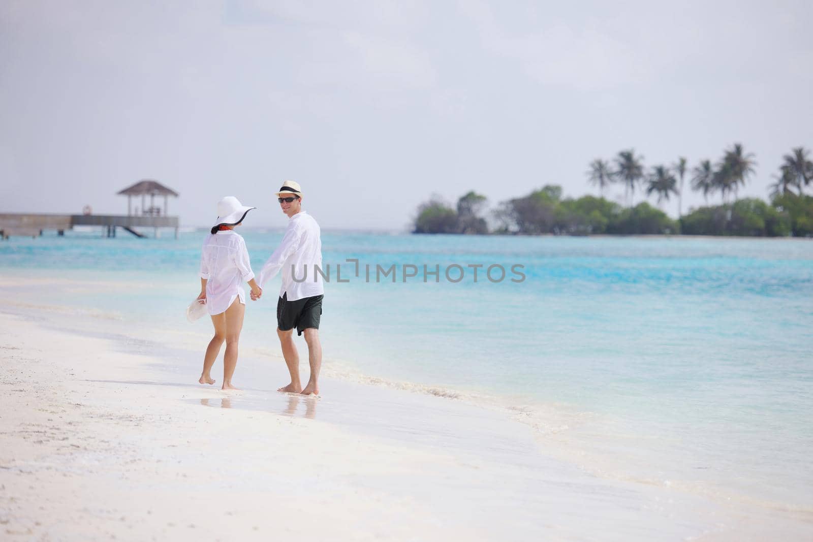 happy young romantic couple in love have fun running and relaxing on beautiful beach